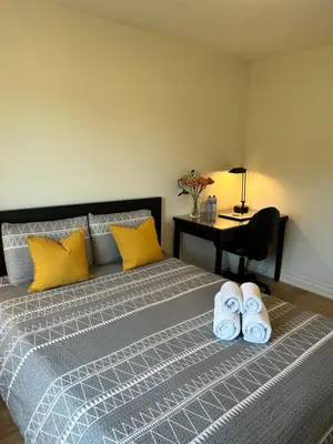 a bedroom with a bed with two towels on it at Super Cosy Peaceful room with Garden view free Parking in Toronto