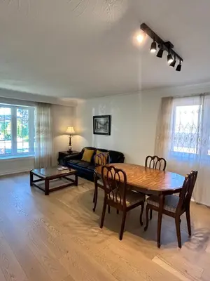 a living room with a table and a couch at Super Cosy Peaceful room with Garden view free Parking in Toronto