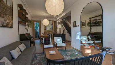 a living room with a couch and a table at Stunning Victorian in Downtown in Toronto