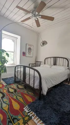 a bedroom with a bed and a ceiling fan at Stunning Victorian in Downtown in Toronto
