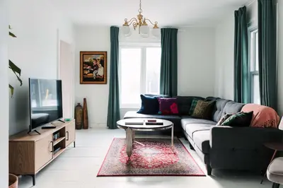 a living room with a couch and a tv at Bloomfield Bliss - Hot Tub and Walking Distance to Park in Bloomfield