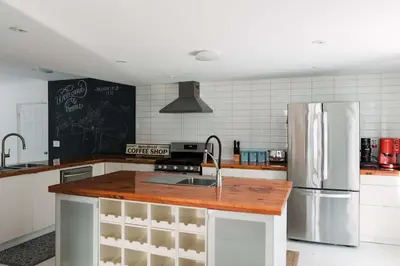 a kitchen with a sink and a refrigerator at Bloomfield Bliss - Hot Tub and Walking Distance to Park in Bloomfield
