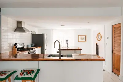 a kitchen with a sink and a counter top at Bloomfield Bliss - Hot Tub and Walking Distance to Park in Bloomfield