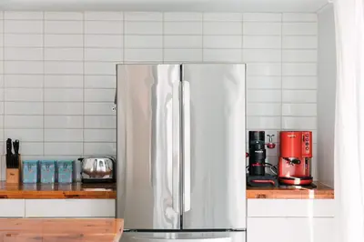 a stainless steel refrigerator in a kitchen at Bloomfield Bliss - Hot Tub and Walking Distance to Park in Bloomfield