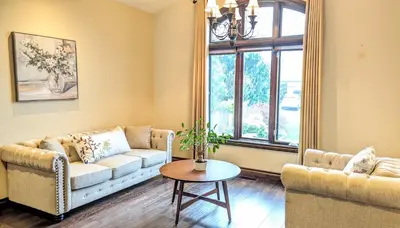 a living room with a couch and a table at Niagara Creekside B&B - Waterfront suite in Niagara Falls