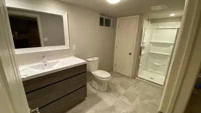 a bathroom with a sink and a toilet and a shower at Cozy Basement in Richmond Hill