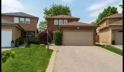 a house with a garage and a parking meter at Cozy Basement in Richmond Hill