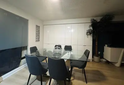 a dining room with a glass table and chairs at LakeView 2Bdrms 2Baths with 3 real beds and parking in Toronto
