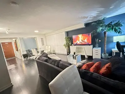 a living room with a couch and a tv at LakeView 2Bdrms 2Baths with 3 real beds and parking in Toronto