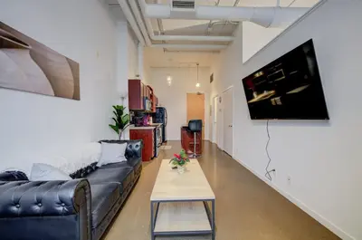 a living room with a couch and a table at Entire 1 bedroom in the heart of KW downtown across Google in Kitchener