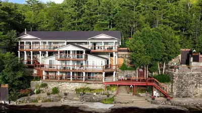a large building on the side of a river at Wollasten Castle with Gorgeous Waterfront in Coe Hill Mines