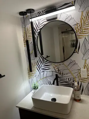 a bathroom with a sink and a mirror at Luxurious modern basement apartment in Pickering