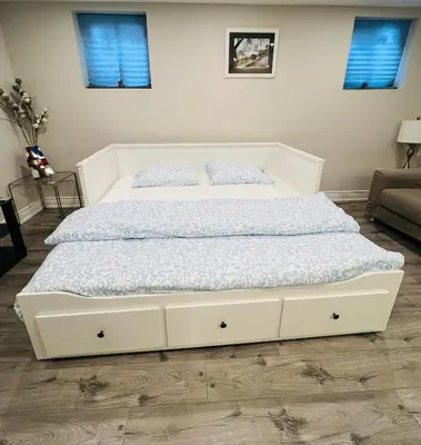 a bed in a bedroom with a white bed frame at CozyHaven A private entrance, comfy basement apartment in Mississauga with free parking Conveniently located with easy access to the airport downtown Toronto major malls and highways for a seamless stay in Mississauga