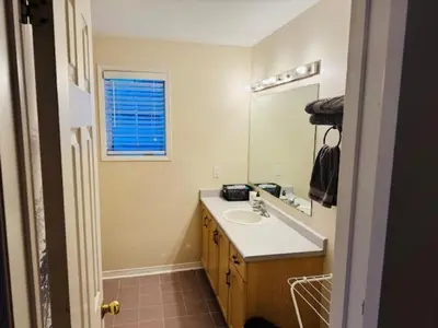 a bathroom with a sink and a mirror at Sunnys Home Stays TorontoMississauga Pvt Entrance 2B'Rm Bath Living & Kitchen in Mississauga