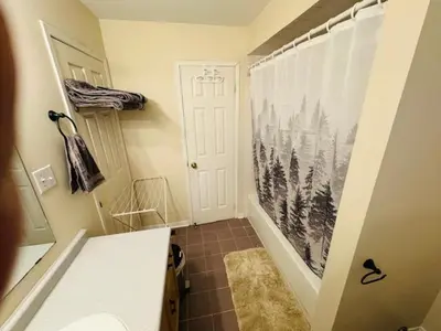a bathroom with a hallway with a shower and a door at Sunnys Home Stays TorontoMississauga Pvt Entrance 2B'Rm Bath Living & Kitchen in Mississauga