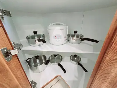 a shelf with three pots and a slow cooker at Harbour for rest in Vaughan