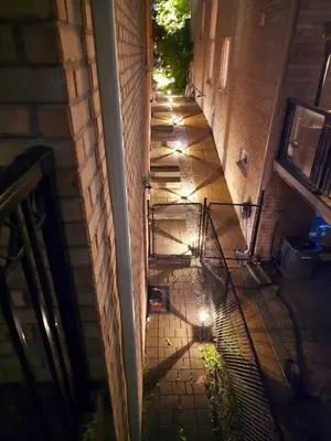 an empty alley way with lights on the side of a building at Harbour for rest in Vaughan