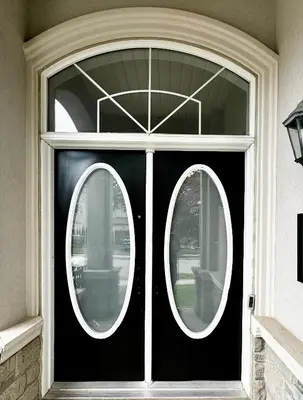 a black front door with two round windows at Modern 1-Bedroom Apartment - Near Airport & Toronto Downtown in Brampton