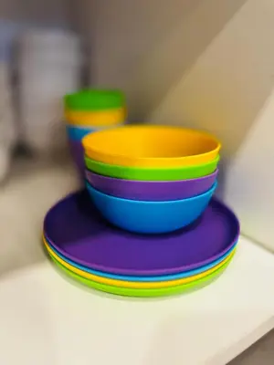 a stack of colorful plates sitting on a shelf at Modern 1-Bedroom Apartment - Near Airport & Toronto Downtown in Brampton