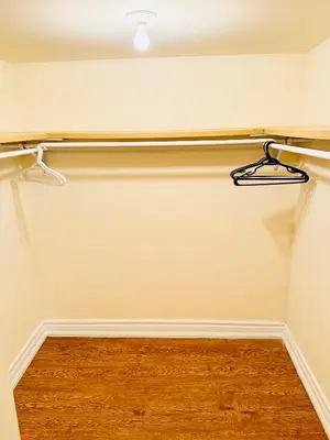 a walk in closet with a wood floor at Modern 1-Bedroom Apartment - Near Airport & Toronto Downtown in Brampton