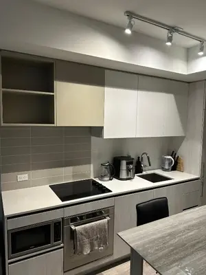 a kitchen with white cabinets and a counter top at The Evergreen Shelter in Vaughan
