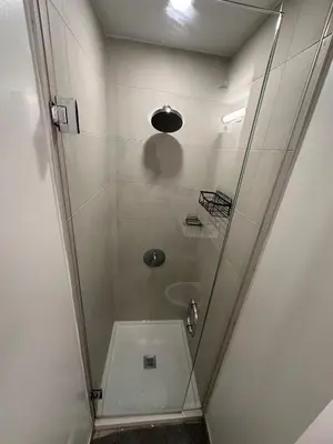 a shower with a glass door in a bathroom at The Evergreen Shelter in Vaughan