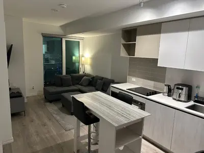 a kitchen and living room with a couch and a table at The Evergreen Shelter in Vaughan