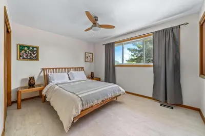 a bedroom with a bed and a ceiling fan at Field of Dreams in Bloomfield
