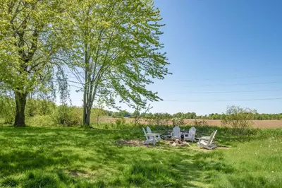 two chairs and a picnic table in a field at Field of Dreams in Bloomfield