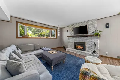a living room with a couch and a fireplace at Field of Dreams in Bloomfield
