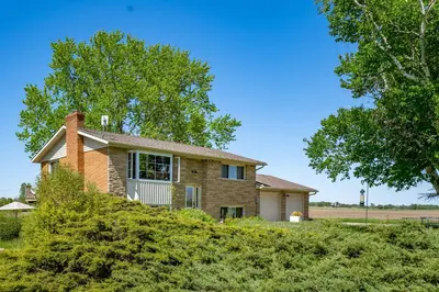 a brick house with a tree in front of it at Field of Dreams in Bloomfield