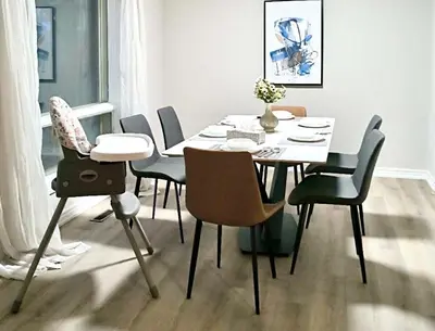 a dining room table and chairs with a white table and chairsktop at Cozy and spacious vacation home in Toronto in Toronto