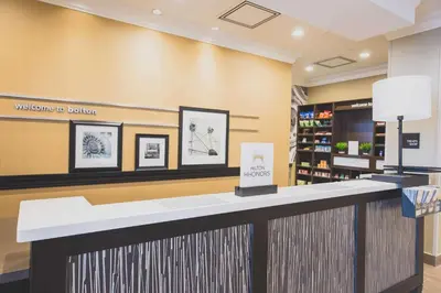 a waiting room with a counter in a store at Hampton Inn & Suites by Hilton Bolton in Bolton