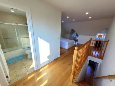 a room with a staircase and a bathroom with a tub at Deluxe Queen Rooms Downtown in Toronto