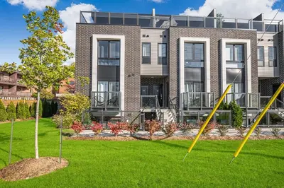 a large building with a lawn in front of it at Cozy 2BR Family Friendly Retreat With Parking and Just 6 Minutes away from Niagara Falls in Niagara Falls