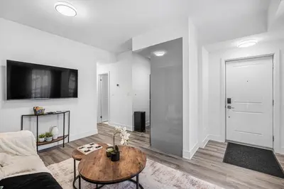 a living room with a couch and a table at Cozy 2BR Family Friendly Retreat With Parking and Just 6 Minutes away from Niagara Falls in Niagara Falls