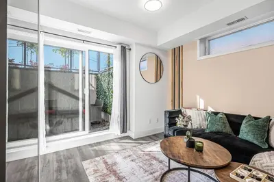 a living room with a couch and a table at Cozy 2BR Family Friendly Retreat With Parking and Just 6 Minutes away from Niagara Falls in Niagara Falls
