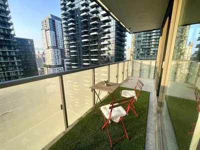a balcony with two chairs and a table on top of a building at Stunning suite in downtown perfect for businesses trips and small families in Toronto
