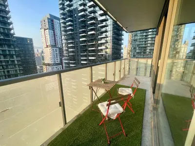 a table and chairs on a balcony with a view of a city at Stunning suite in downtown perfect for businesses trips and small families in Toronto