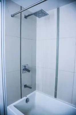 a bathroom with a shower and a tub with a glass door at Stunning suite in downtown perfect for businesses trips and small families in Toronto