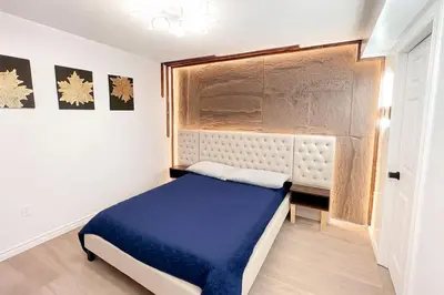 a bedroom with a blue bed and a window at Private Room Near Airport D9 in Brampton
