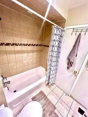 a bathroom with a tub and a toilet and a sink at Private Room Near Airport D10 in Brampton
