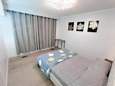 a bedroom with a bed and a large window at Private Room Near Airport D10 in Brampton