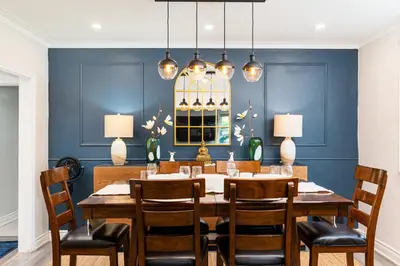a dining room with blue walls and a table and chairs at Resort-like 4BR 3BA near Downtown, Four seasons Hot Tub, Gym, King Bed in Toronto