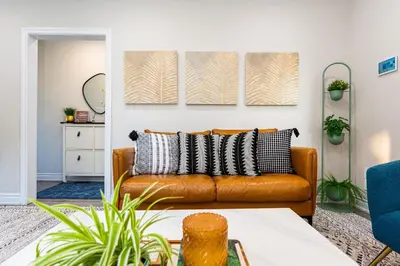 a living room with a brown leather couch at Resort-like 4BR 3BA near Downtown, Four seasons Hot Tub, Gym, King Bed in Toronto