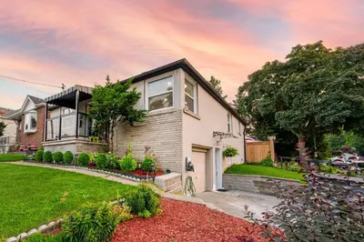 a house with a garden in front of it at Resort-like 4BR 3BA near Downtown, Four seasons Hot Tub, Gym, King Bed in Toronto