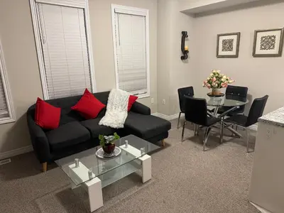 a living room with a couch and a table at A Compact family home in Milton in Milton