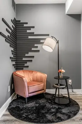 a living room with a pink chair and a lamp at NEW Stylish 1BR Apartment With BBQ and Situated Close to the Falls and Can Sleep 4 Guests in Niagara Falls