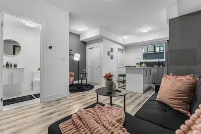 a living room with a couch and a table at NEW Stylish 1BR Apartment With BBQ and Situated Close to the Falls and Can Sleep 4 Guests in Niagara Falls
