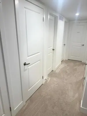 a hallway with white doors and carpet at LuxSpace Properties in London